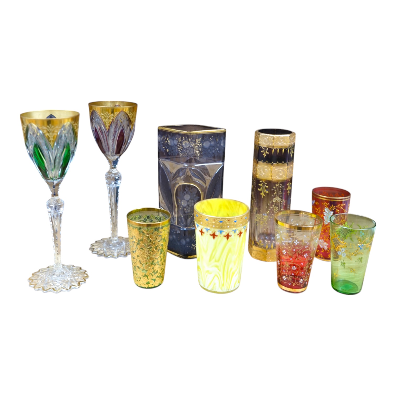 Nine Bohemian decorated glass items including a gilt rimmed and decorated glass inscribed ‘Moser 1503 D553/a’, four smaller glasses, a pair of tall stemmed glasses, 22.5cm, and two vases, tallest 19.5cm. Condition - good